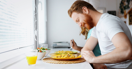 Couple in love having breakfast at homeの写真素材