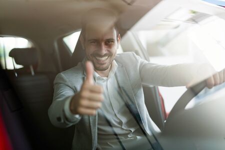 Portrait of happy customer buying new car