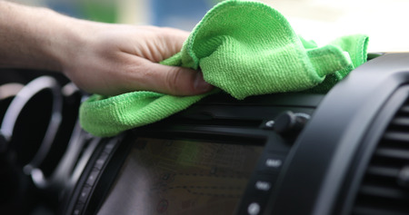Hand cleaning car steering wheel with microfiber cloth