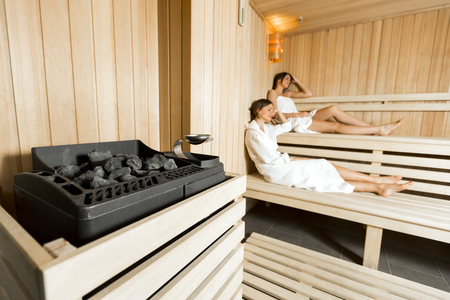 Sauna heater and girls relaxingの写真素材