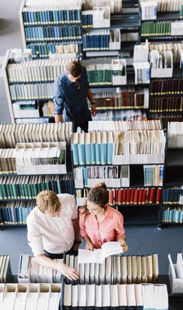 Students learning, reading in the libraryの写真素材