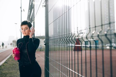 Fit beautiful sporty woman outdoor before fitness exercisingの写真素材