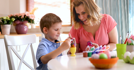 Mother and son paint Easter eggsの写真素材
