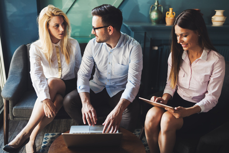 Happy colleagues from work socializing in restaurantの写真素材