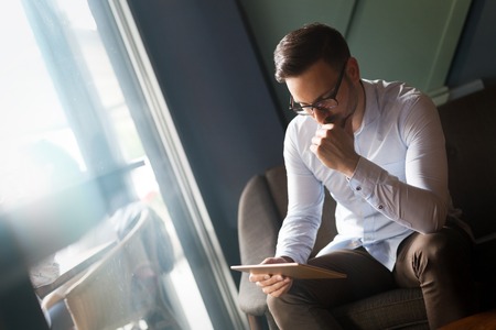 Portait of young handsome businessman in glassesの写真素材
