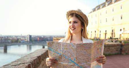 Tourist woman holding travelers mapの写真素材