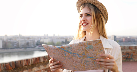 Tourist woman holding travelers mapの写真素材