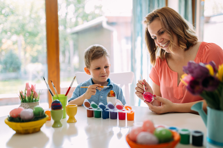 Mother and son are painting eggsの写真素材