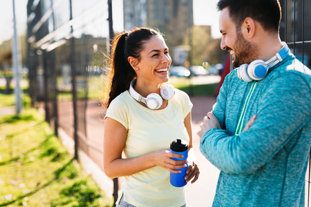 Handsome man and attractive woman talking on courtの写真素材