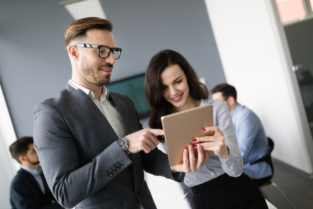 Happy business colleagues in modern officeの写真素材