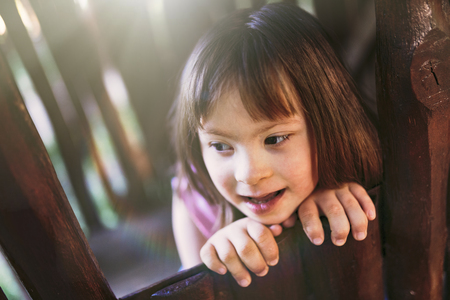 Portrait of beautiful little girl with down syndromeの写真素材