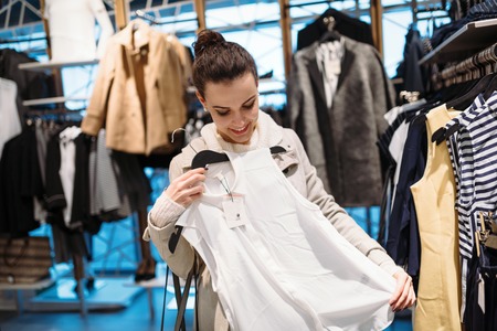 Young attractive woman buying clothes in mallの写真素材
