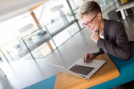 Portrait of businesswoman working on computer in officeの写真素材