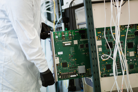 Picture of technician repairing cmts networking cards