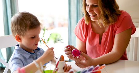 Mother and son are painting eggsの写真素材
