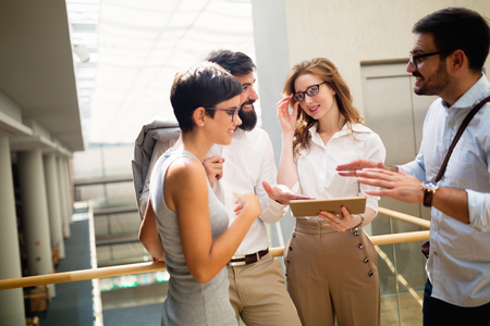 Group of young perspective businesspeople having discussionの写真素材