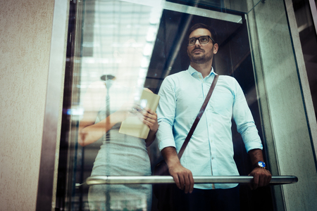 Businessman taking the elevatorの写真素材