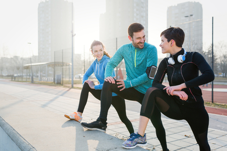 Friends fitness training together outdoors living active healthyの写真素材