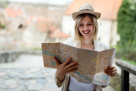 Happy blond female traveling and sightseeingの写真素材