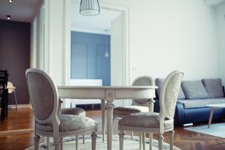 Bright spacious living room with chairs table insideの写真素材