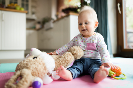 Baby toddler playing color toys at home or nurseryの写真素材