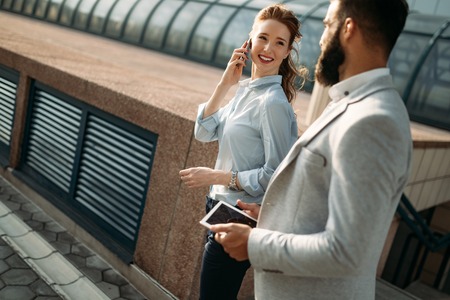 Business people walking and talking outdoorの写真素材