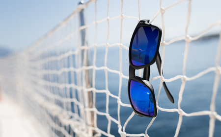 Picture of cool sunglasses hanging on netの写真素材
