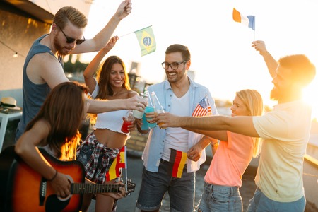 Group of happy friends having party on rooftop
