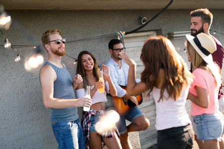 Friends having fun at rooftop party.の写真素材