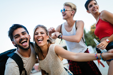 Happy friends having fun at music festivalの写真素材