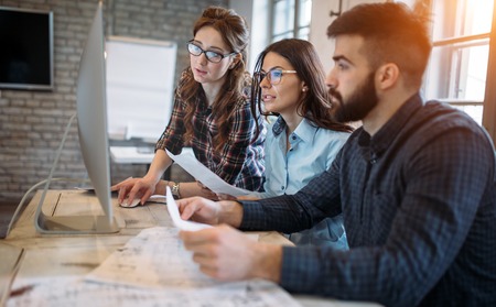 Young architects working on project in officeの写真素材
