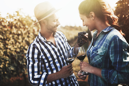 People tasting wine in vineyardの写真素材