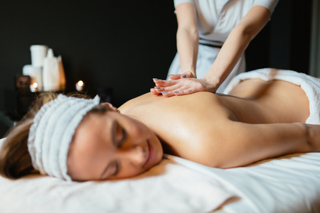 Beautiful woman enjoying massage treatmentの写真素材