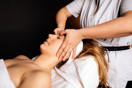 Beautiful woman enjoying massageの写真素材