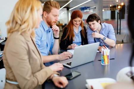 Business people brainstorming in office at deskの写真素材