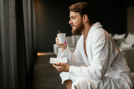 Handsome man drinking teaの写真素材
