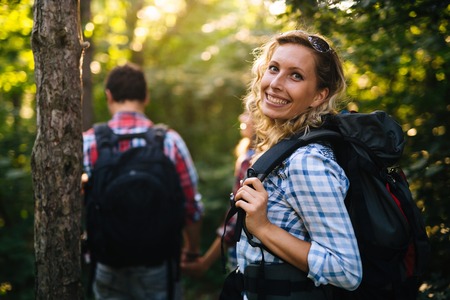 Couple trekking and hiking in forest