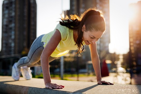 Young sportswoman stretching and preparing to run.の写真素材