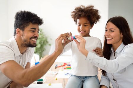 Family lifestyle portrait of a mum and dad with their kid