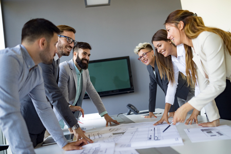 Team of architects working on construction plansの写真素材
