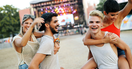 Group of friends having fun time at music festival