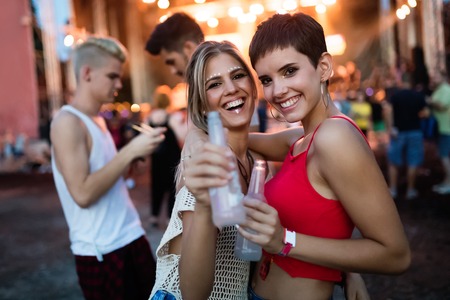 Happy friends having fun at music festivalの写真素材