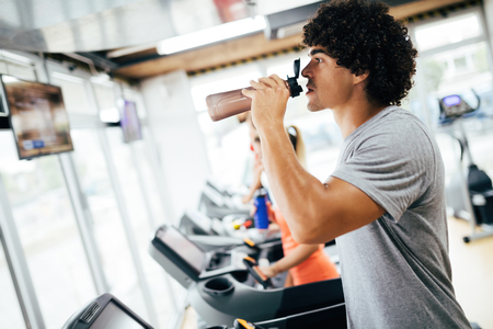 Young handsome man doing cardio training in gymの写真素材