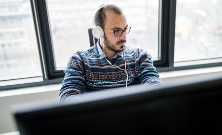 Software engineer programming in office