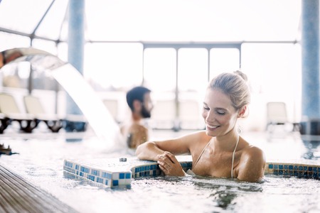 Portrait of beautiful woman relaxing in swimming pool