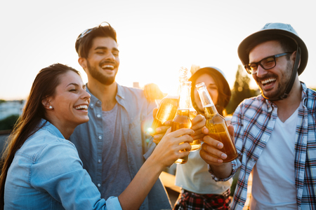 Group of happy friends having party on rooftopの写真素材
