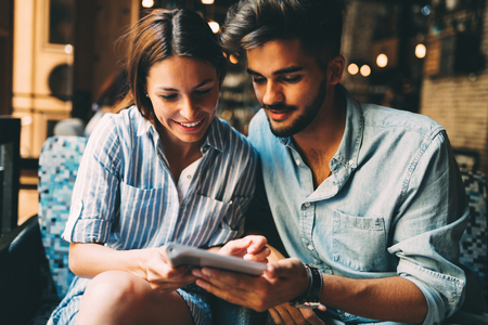 Young attractive couple on date in coffee shopの写真素材