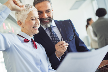 Senior business accountants working together at modern officeの写真素材
