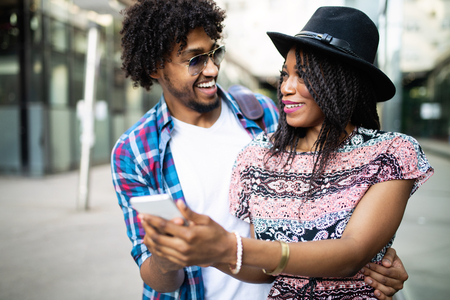 Beautiful young couple enjoying in good mood in city. Lifestyle, love, dating, vacation conceptの写真素材