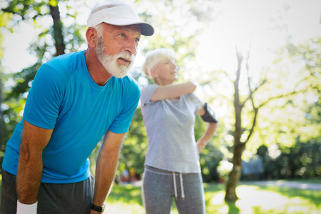 Mature couple jogging and running outdoors in cityの写真素材